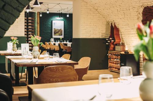 a restaurant with tables and chairs in a room at Stokker Hotel in Oradea
