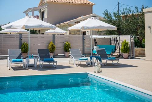 a swimming pool with chairs and umbrellas next to a pool at Lefkimmiatis Villas Corfu in Afionas