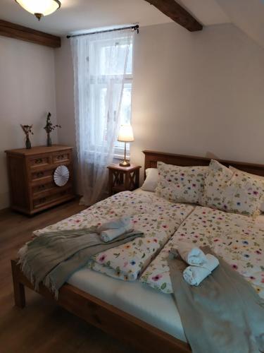 a bedroom with a bed with two towels on it at Penzion U Křížku in Malá Morávka