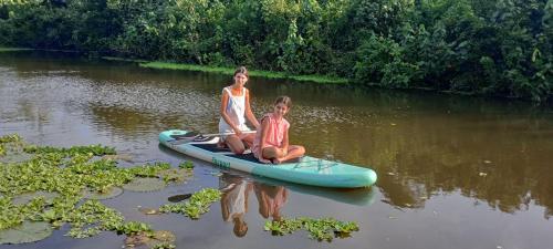 two girls sitting on a raft in the water at Bali Villa Mirissa in Mirissa