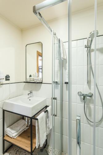 a bathroom with a sink and a shower at Stokker Hotel in Oradea