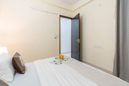 a bedroom with a bed with a mirror at Homlee-Vasundhara 3BHK Flat- kitchen-Parking-Lift in Ghaziabad