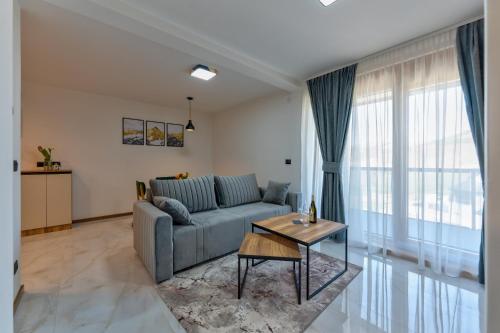 a living room with a couch and a table at Golden Panorama Spa & Wellness in Zlatibor