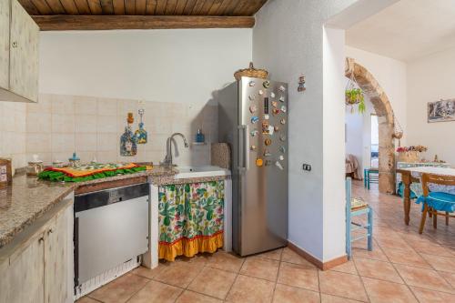 a kitchen with a stainless steel refrigerator and a sink at Sara Home in Portopalo