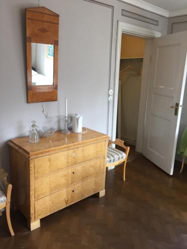 a room with a wooden dresser and a mirror at Forsbacka Wärdshus in Forsbacka