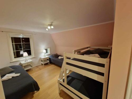 a bedroom with two bunk beds and a window at Gula Villan in Gothenburg