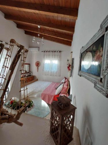 a bedroom with a bed and a swing at Boheme studio Artemis in Áyios Spirídhon