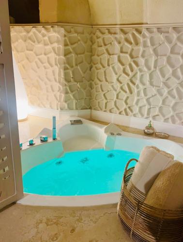 a bath tub with a blue pool in a room at Stone House in Matera