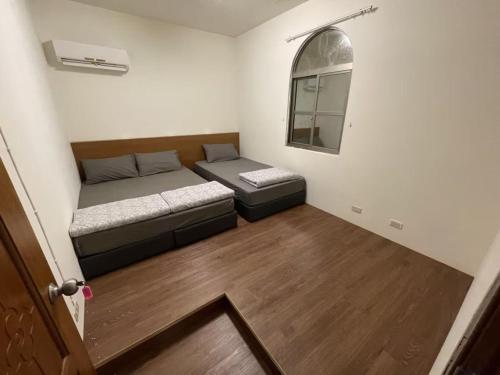 a small room with a bed and a mirror at Lanyu Yishanan B&B in Lanyu