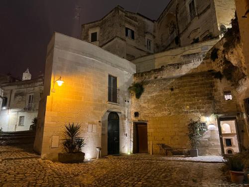 an old stone building with a light on it at night at Stone House in Matera