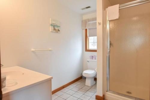 a bathroom with a toilet and a sink and a shower at 12217 - Beautiful Views of Cape Cod Bay Access to Private Beach Easy Access to P-Town in Truro