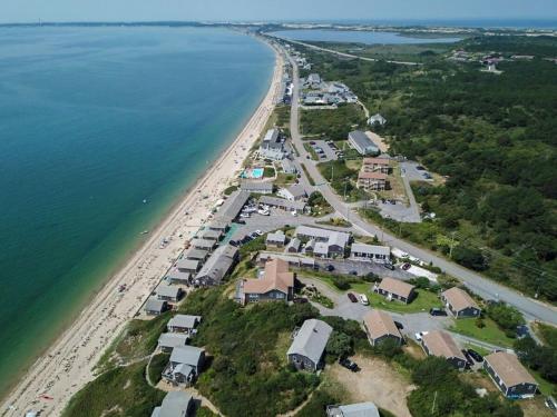an aerial view of a beach with houses and the water at 12215 - Beautiful Views of Cape Cod Bay Access to Private Beach Easy Access to P-Town in Truro