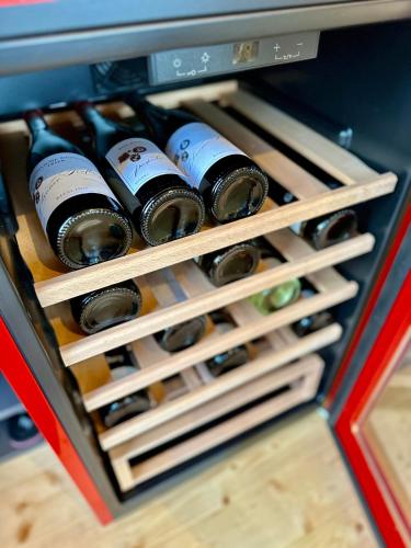 a bunch of wine bottles in a drawer at Chalet Lasserg in Münstermaifeld