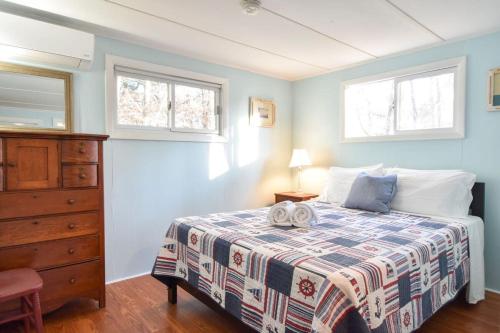 ein Schlafzimmer mit einem Bett mit zwei Handtüchern darauf in der Unterkunft Walk to Private Beach Dogs Welcome in Eastham