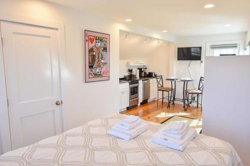 a bedroom with a bed with two towels on it at East End Condo w Beach Access in Provincetown