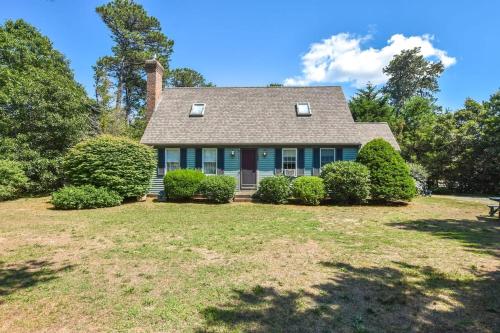a house with a yard with bushes and trees at Lovely Home Close to Bike Bath and Beach in Eastham