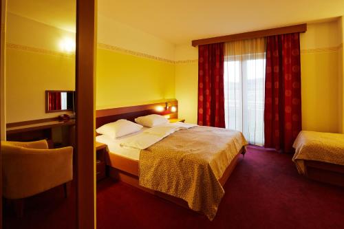 Ένα ή περισσότερα κρεβάτια σε δωμάτιο στο Hotel Vila Emei