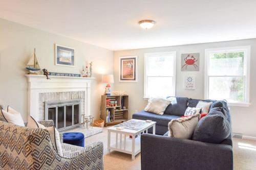 a living room with a couch and a fireplace at 14443 - Expansive Home Abutting Rail Trail Near First Encounter and Hatch Beaches in Eastham