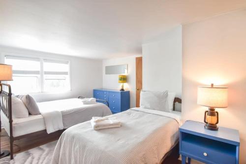 a hotel room with two beds and a couch at Marsh Front Home w Sweeping Views in Wellfleet
