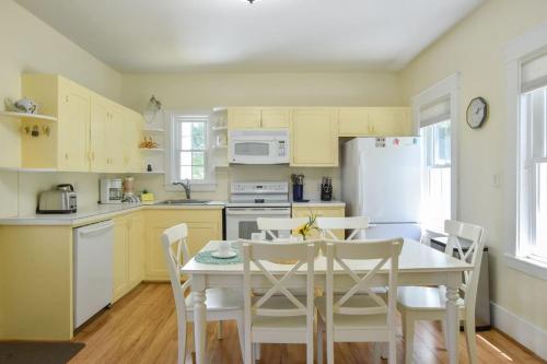 a kitchen with a table and a white refrigerator at Private Downtown Wellfleet Location in Wellfleet