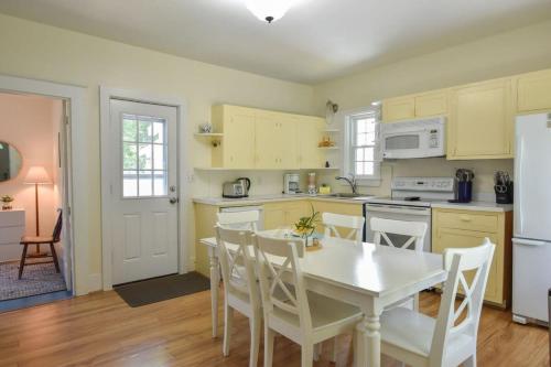 a kitchen with a white table and white appliances at Private Downtown Wellfleet Location in Wellfleet