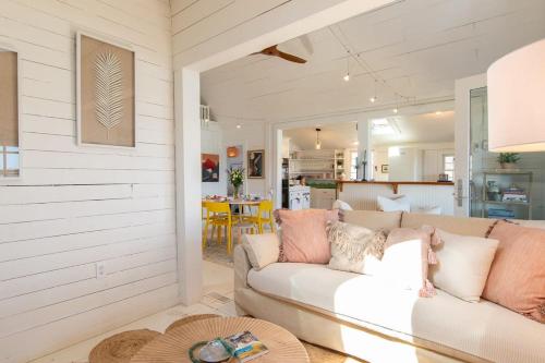 a living room with a couch and a table at Seaside Retreat w Private Beach Landing in Eastham