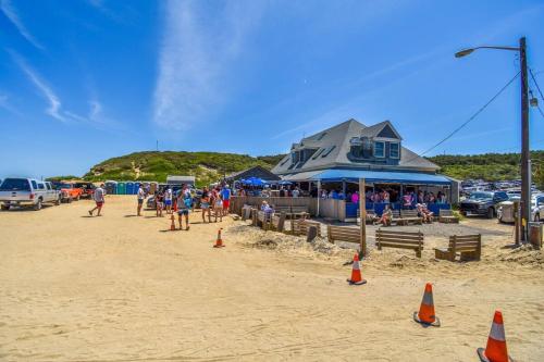 a group of people on a beach with orange cones at Short Walk to Long Pond Swimming Beach in Wellfleet