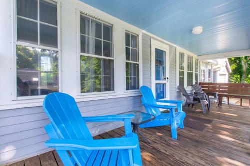 a porch with blue chairs on a house at Walk to Restaurants Shopping & Harbor in Wellfleet