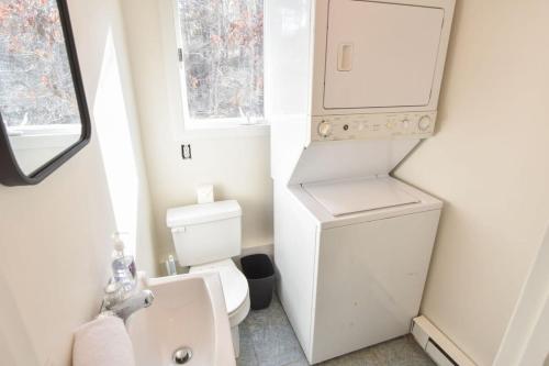 a small bathroom with a toilet and a sink at Private Location w Guest House in Wellfleet