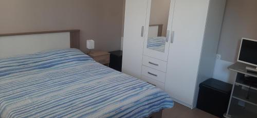 a bedroom with a bed and a dresser and a television at Clara 3 in Poreč