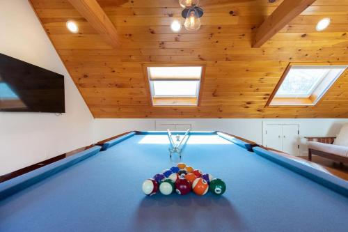 a pool table in a room with wooden ceilings at 3000 Sq Ft Home with Hot Tub in Eastham