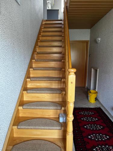 a stairway with wooden steps in a house at FeWo 1 Am Sportplatz 2 in Ueckeritz