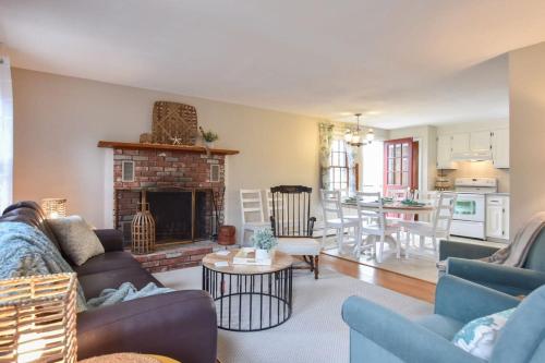 a living room with a couch and a fireplace at Minutes to Oceanside Beaches in Eastham