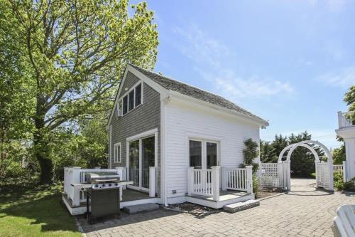 a white house with a porch and a patio at Waterfront Fun at this Huge Family Estate in Eastham