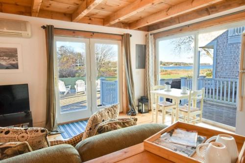 a living room with a couch and a table at Waterfront Fun at this Huge Family Estate in Eastham