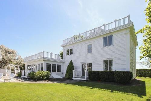 a large white house with a yard at Waterfront Fun at this Huge Family Estate in Eastham