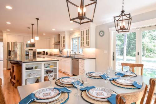 a kitchen with a table with blue and white dishes at Walk to Water Gorgeous Outdoor Space in Eastham