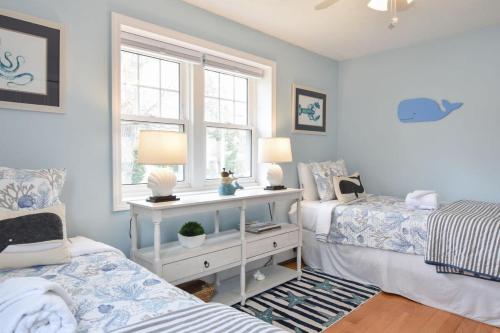 a bedroom with two beds and a window at Minutes to Private Association in Eastham