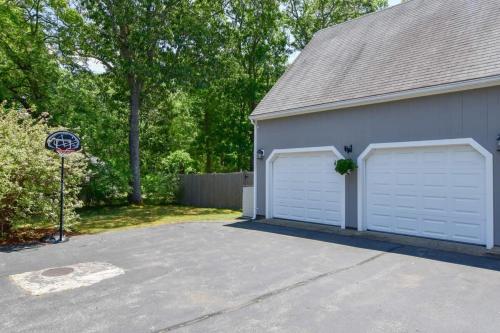 a garage with two white garage doors and a stop sign at Minutes to Private Association in Eastham