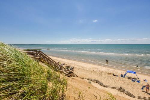 a beach with people on the sand and the ocean at Minutes to Private Association in Eastham