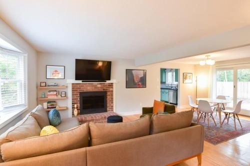 a living room with a couch and a fireplace at Sunroom Expansive Patio Fenced Yard in Eastham