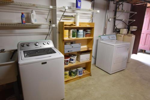 a kitchen with a stove and a washing machine at Sunroom Expansive Patio Fenced Yard in Eastham