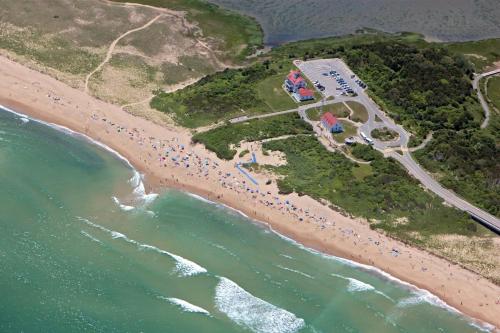 an aerial view of a beach with the ocean at Sunroom Expansive Patio Fenced Yard in Eastham