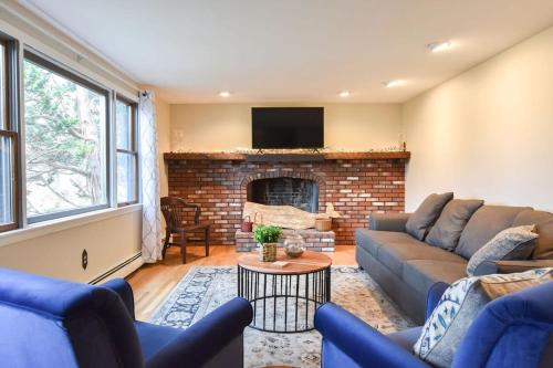 a living room with a couch and a fireplace at 4 Mins to Bayside Beaches in Eastham