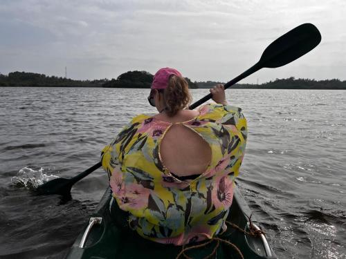 a woman is in a kayak on the water at Bali Villa Mirissa in Mirissa