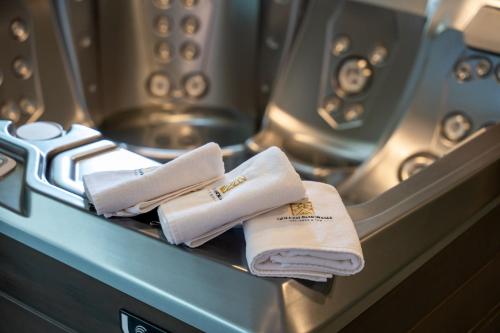 a group of white towels sitting on a stove at Golden Panorama Spa & Wellness in Zlatibor