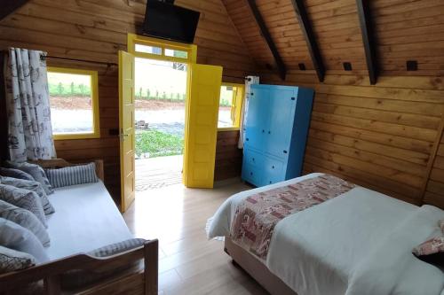 Postel nebo postele na pokoji v ubytování Chalé do Vale Pomerode