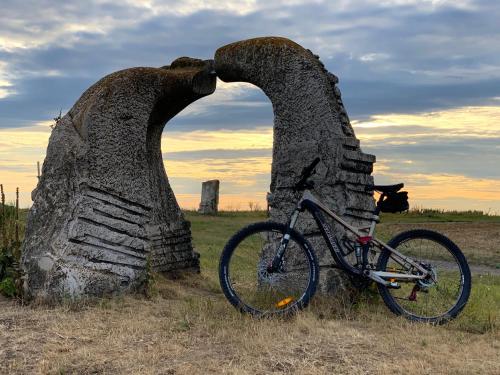 a bike parked next to a stone arch in a field at Hotel Ponteo - Activity Park in Bratislava
