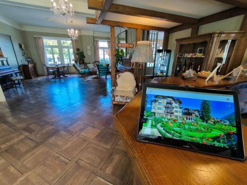 a laptop computer sitting on a table in a living room at Alpenrose Hotel and Gardens in Wilderswil