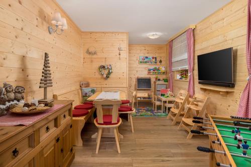 a childrens room with wood paneling and a television at Forest Tale - Šumska priča in Crni Lug